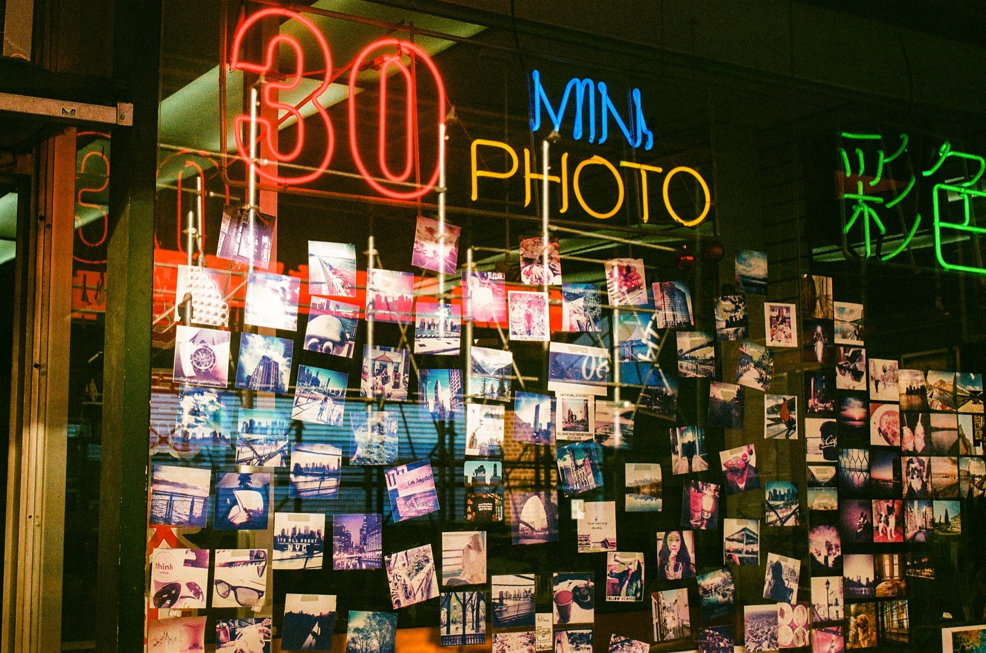 '30 Min Photo' neon storefront at night